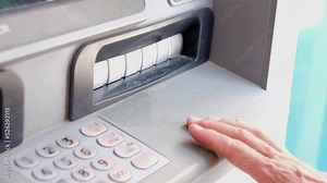 Man waiting money from an automated teller machine. Depositor withdraws cash money from ATM.