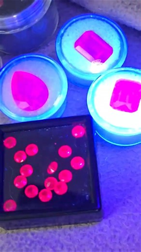 more of the ruby gemstones glowing under UV