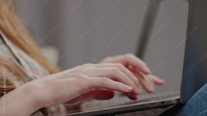 Side view young woman sitting with laptop, close up the hands of an unrecognizable woman typing on a laptop keyboard, chatbot query, web surfing, research, e-learning, search query, social networking