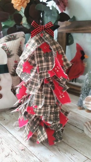 Christmas Rag Tree using 3 inch Wood Slices, a wooden dowel and fabric cut to 9 inch pieces tied around the wooden dowel 🎄I used a one sided fabric but it would be best to use a double sided fabric if possible ❤️ #christmasdiy #rusticchristmas #poinsettiasforchristmas #christmastree #christmasgiftideas #Winterdecor #christmasdecor #christmascrafts #primitivechristmas | Love Crafted Decor