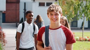 Portrait Of Male Teenage Student Walking Around College Campus