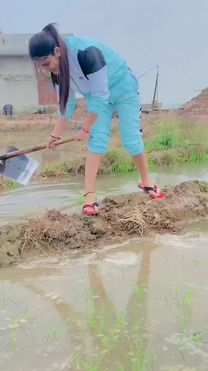 Young Woman Working in a Muddy Field