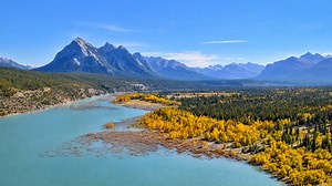 Canadian Rockies reflect over turquoise Abraham Lake waters