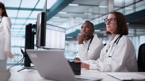 clip-3779459951-doctor-showing-medical-codes-training-presentation-hospital