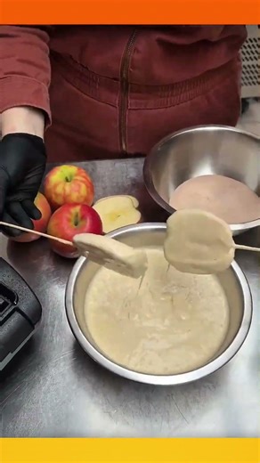 Apple halves skewered with sticks, dipped in batter, then pressed and cooked on a hot teflon pan.