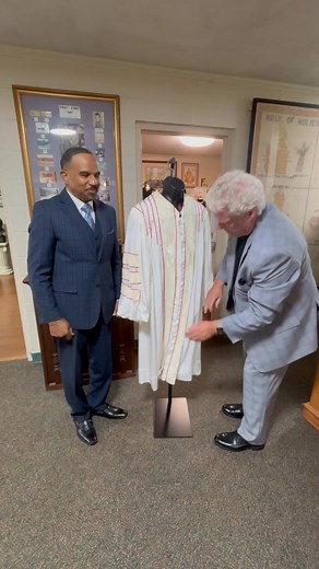 Bishop Donald Golder helping place Bishop M.E. Golder’s Clergy Robe on a mannequin at the Heritage Center. (10-15-25) | Apostolic Archives International