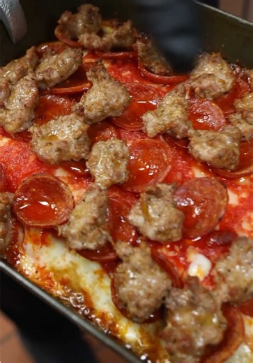 If you're heading to @Pizza Payaa , the Hot HoneyBadger is a must-order. This pizza cracked the top 10 in the world, and one bite tells you why. The ingredients speak for themselves: quality cheese, pepperoni, and sausage, all paired with a crust that's made days in advance and given time to ferment properly. That patience shows up in every slice. And when it comes out of the oven, the cheese melts all the way to the edges, meaning the corner pieces are in a league of their own.