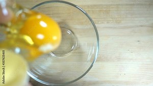 Raw egg falls in slow motion into a transparent bowl. Stock Video