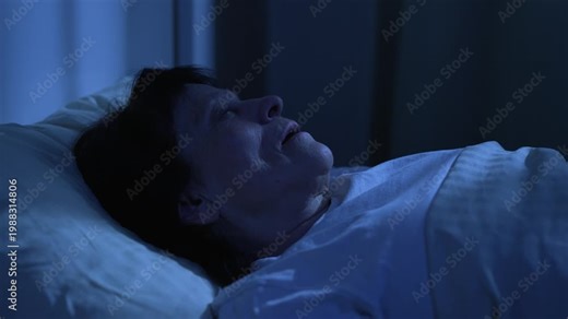 Woman sleeping and snoring with mouth open at night