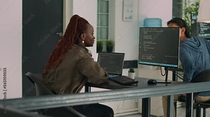 Two software coders analyzing source code on computer and laptop screen, using html script on terminal window. Team of system engineers working on cyber security innovation in it agency.