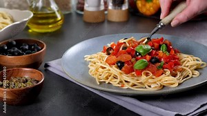 Italian spaghetti alla Pultanesca with tomatoes and olives. Served without meat and cheese.