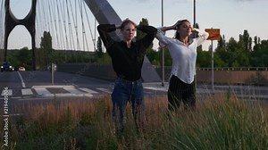 Two Young Women Dancing in the Middle of a Roundabout