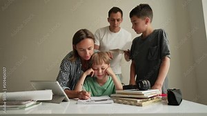 Father helping his son with schoolwork. Young little shoolboy solving mathematics homework with his family