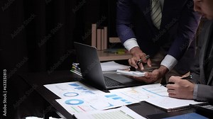 Business team finance or bookkeeper working with a calculator to calculate business data summary report, accountancy document and laptop computer at the office, business meeting concept