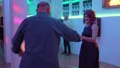 Cheerful mature couple dancing salsa at the party indoor