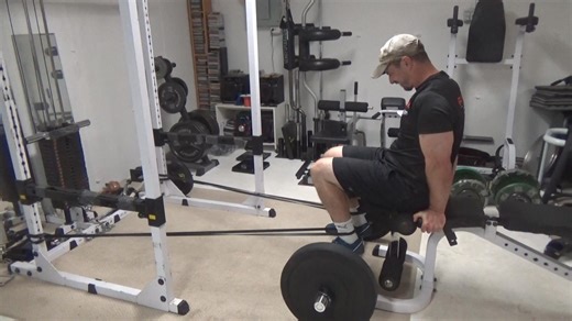 Banded Rolling Seated Leg Curls...if you train at home, in a garage gym or basement gym, a seated leg curl machine isn't generally something you'll have access to. Yet the seated leg curl IS a good hamstring exercise. This rigged-up version of the exercise gives you a decent facsimile of the movement (not exactly the same because we can't duplicate the rotary arm easily) in order to get a solid contraction on the hamstrings at the top of the rep. I've got a couple of small black bands hitched to