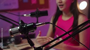 Professional female radio host Podcasts and live broadcasts A beautiful, happy and cheerful Asian woman talks and hosts a radio program, giving knowledge, ideas, and entertainment in the studio.