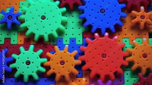 Plastic toy cogwheel Working for common goal, conceptual. Gears and cogs in action. Team work conceptual. Parts of whole mechanism working in cooperation. Close up. Simple mechanism. Basics of