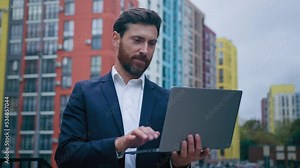 Focused caucasian businessman professional employee 30s man work freelance outside office in city use portable laptop study internet course develop computer software chatting online distance connect