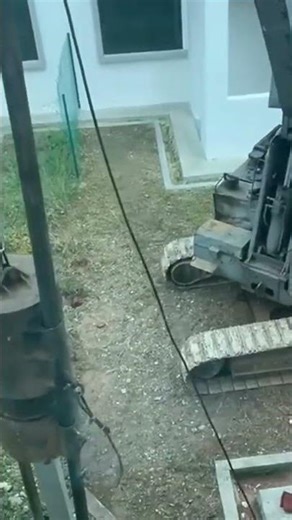 Driving a ground rod using heavy equipment,ensuring placement,strong grounding,reliable installation