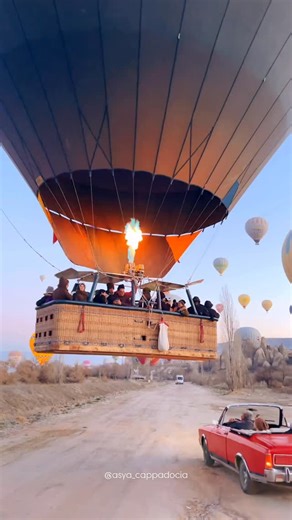 Asya Sertkaya 🇹🇷 Cappadocia on Instagram: "Cappadocia is the kind of place where even an ordinary morning and a simple car ride suddenly turn into an adventure 🤩🙌🏻 Especially when the road takes you right beneath hot air balloons 🎈 And of course whenever you are planning a trip to Cappadocia, we are always here to help you organize it! To book a private tour, hot air balloon flight and any activities in Cappadocia, just send a DM 😉 And all our services, prices and programs you can find at