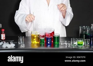 Scientist conducts experiment with colorful liquids