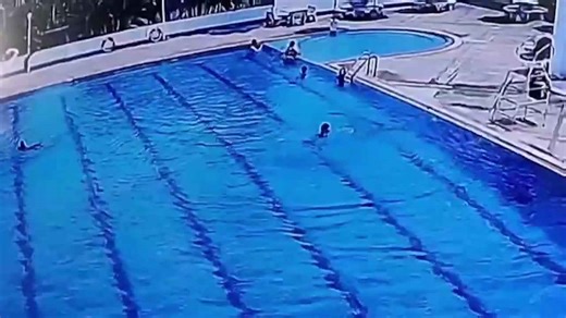 Quick-thinking security guard leaps into pool to rescue struggling child