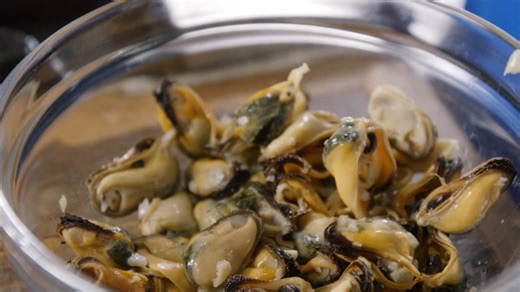 Preparing fresh mussels with garlic and Greek white wine