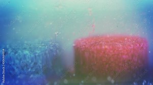 Blue and red pill dissolving in clear liquid. Drug laboratory concept