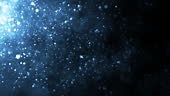 Blue-colored underwater dust particles moving under rim light tiny...