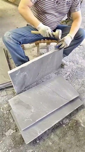 Skilled Artisan Manually Splitting Natural Slate Stone Tiles With Precision Tools