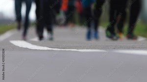 Blurred legs running athletes shod in sneakers. Background on running theme, empty space for text. Slow motion. Stock Video