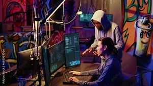 Hackers in underground hideout discussing ways to best hide their online activity through VPN and other methods after stealing data from victims, trying to avoid being detected by cybercrime police