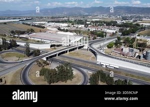 Aerial View of a Highway Interchange Overpass near Industrial Buildings and Mountains Stock Video Footage - Alamy