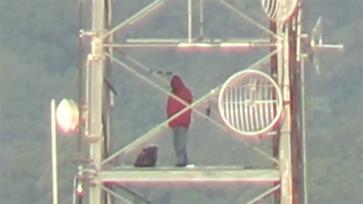 Man on DC radio tower as police standoff extends 24 hours