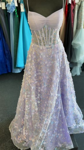✨BRAND NEW PROM DRESSES IN STORE NOW✨ Come along this half term and try on new collection from Romantica. ✨ A-line prom dress featuring delicate spaghetti straps and a sweetheart neckline. The illusion corset bodice adds a touch of elegance, adorned with 3D floral appliqués and sparkling details that catch the light beautifully Seen here in lilac but also available to order in pink and blue. Store sample size 10 | Susans of Gosport Bridal Shop | Facebook