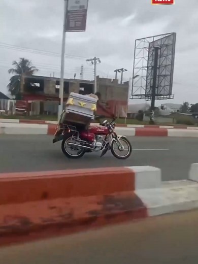 Nigeria Motorcyclist Performs Wheelies While Carrying Casket in Uyo