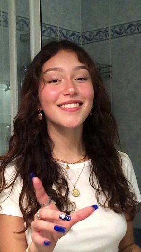 Hand Gestures and Style in a Blue Bathroom