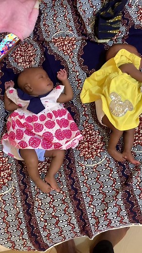 Adorable Infants in Colorful Outfits on Patterned Fabric