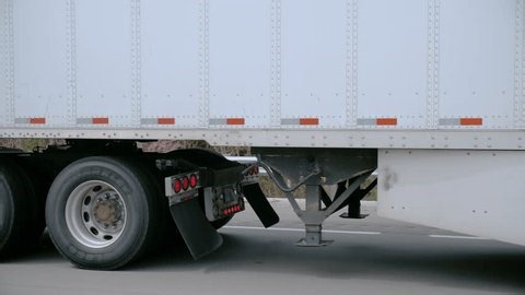 clip-3968220075-pov-close-semi-truck-wheels-axle-fuel-tank
