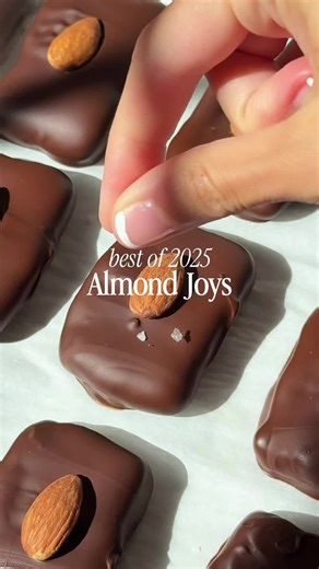 BEST OF 2025 #2 ✨ Homemade Almond Joys 🥥 these were part of my better-for-you candy series and they were a hit! RECIPE: - 1 ½ cups unsweetened shredded coconut - 1/2 cup firm coconut cream - 2 tbsp maple syrup - 1 tbsp softened coconut oil - 1 cup vegan chocolate chips - 12 whole almonds Scoop out the thick layer of coconut cream from the top of your chilled can of coconut milk. Add it to a food processor with the shredded coconut, maple syrup, and softened coconut oil. Blend until smooth, then