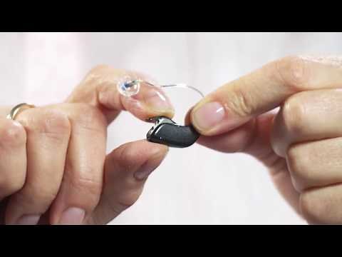 How to place the Oticon hearing aid with dome on the ear