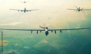 Military drones flying over a desert landscape for reconnaissance and combat missions.