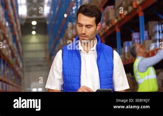 Supervisor scanning warehouse, tapping tablet updating stock, curved graphics rising around tablet. Inventory, manager, shelving, racking, pallets, logistics, device Stock Video Footage - Alamy