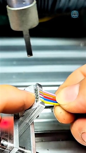 The video depicts a person performing an assembly task, likely in an electronics or manufacturing