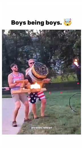 Films | Movies | Tv series on Instagram: "The post shares a 31-second video of men in American flag-themed attire igniting a homemade fireworks-filled barrel in a backyard, unleashing chaotic flames and explosions amid laughter and evasion. Uploaded by @Crazy_Videozzz , a channel curating extreme online clips, it amassed 1,557 likes and 438,000 views in under 24 hours, indicating rapid viral traction for its high-energy spectacle. User reactions emphasise its embodiment of bold American festivit