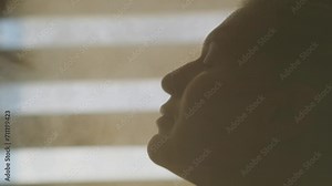 Beautiful adult woman steaming her face in a spa. Close-up female profile in a stream of water vapor. Humidifier for home, adds moisture into dry air. Aromatherapy concept.