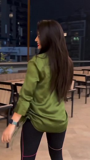 Stylish Nighttime Outdoor Fashion: Green Top & Leggings