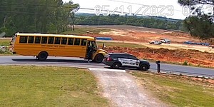 Police officer caught on video passing school bus suspended