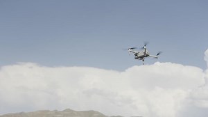 View of the drone agains blue sky. Action. Wide beautiful sky. Drone flying in the blue sky. Cloudy sky.